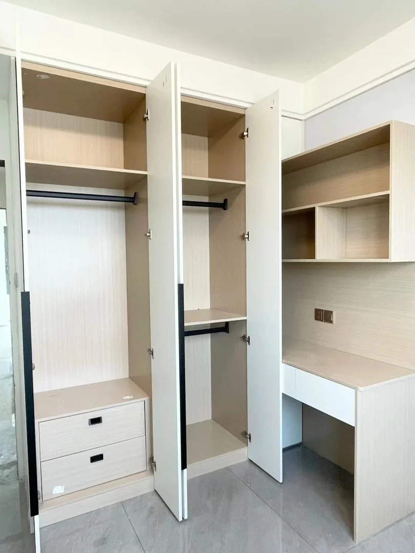 Open wardrobe interior with shelves, hanging space and drawers for a Singapore home